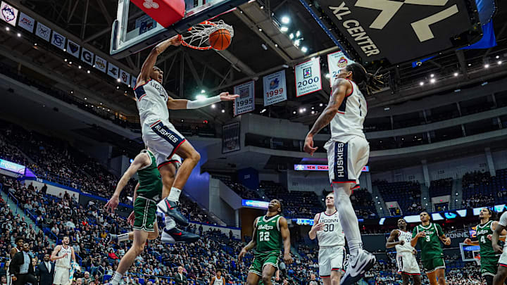 UConn Huskies forward Jayden Ross gets up for a jam against the Le Moyne Dolphins.