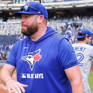 Sep 21, 2025; Kansas City, Missouri, USA; Toronto Blue Jays manager John Schneider (14) congratulates players on field after the win over the Kansas City Royals at Kauffman Stadium. 