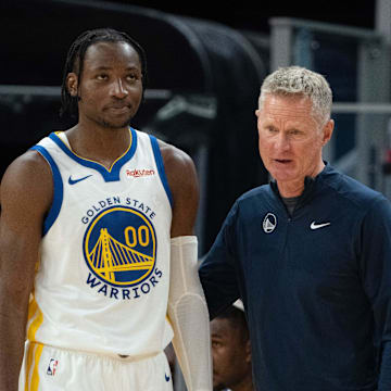 October 20, 2023; San Francisco, California, USA; Golden State Warriors head coach Steve Kerr (right) talks to forward Jonathan Kuminga (00) during the third quarter against the San Antonio Spurs at Chase Center. Mandatory Credit: Kyle Terada-Imagn Images