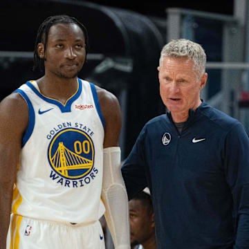 October 20, 2023; San Francisco, California, USA; Golden State Warriors head coach Steve Kerr (right) talks to forward Jonathan Kuminga (00) during the third quarter against the San Antonio Spurs at Chase Center. Mandatory Credit: Kyle Terada-Imagn Images
