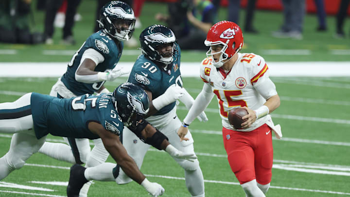 Kansas City Chiefs quarterback Patrick Mahomes (15) scrambles away from Philadelphia Eagles defensive end Brandon Graham (55) in the third quarter in Super Bowl LIX at Caesars Superdome.