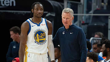 October 20, 2023; San Francisco, California, USA; Golden State Warriors head coach Steve Kerr (right) talks to forward Jonathan Kuminga (00) during the third quarter against the San Antonio Spurs at Chase Center. Mandatory Credit: Kyle Terada-Imagn Images
