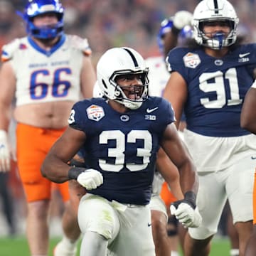 Penn State Nittany Lions defensive end Dani Dennis-Sutton (33) celebrates his tackle of Boise State Broncos running back Ashton Jeanty (2) during the Fiesta Bowl.