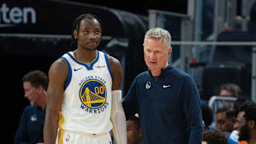 October 20, 2023; San Francisco, California, USA; Golden State Warriors head coach Steve Kerr (right) talks to forward Jonathan Kuminga (00) during the third quarter against the San Antonio Spurs at Chase Center. Mandatory Credit: Kyle Terada-Imagn Images