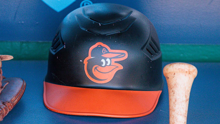 Apr 21, 2024; Kansas City, Missouri, USA; Baltimore Orioles hat and glove sits in the dugout during the ninth inning against the Kansas City Royals at Kauffman Stadium.