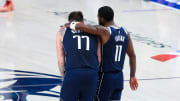 May 26, 2024; Dallas, Texas, USA; Dallas Mavericks guard Luka Doncic (77) and Dallas Mavericks guard Kyrie Irving (11) hug during the fourth quarter against the Minnesota Timberwolves during game three of the western conference finals for the 2024 NBA playoffs at American Airlines Center. Mandatory Credit: Kevin Jairaj-USA TODAY Sports