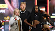 Apr 9, 2025; New York, New York, USA; Dina Thorslund (left) and Shurretta Metcalf pose in front of Jake Paul after a press conference ahead of their boxing match at Madison Square Garden. Mandatory Credit: Vincent Carchietta-Imagn Images