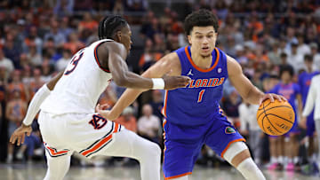 Feb 8, 2025; Auburn, Alabama, USA;  Florida Gators guard Walter Clayton Jr. (1) runs a play as Auburn Tigers guard Miles Kelly (13) defends during the first half at Neville Arena. Mandatory Credit: John Reed-Imagn Images