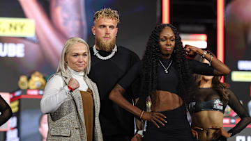 Apr 9, 2025; New York, New York, USA; Dina Thorslund (left) and Shurretta Metcalf pose in front of Jake Paul after a press conference ahead of their boxing match at Madison Square Garden. Mandatory Credit: Vincent Carchietta-Imagn Images