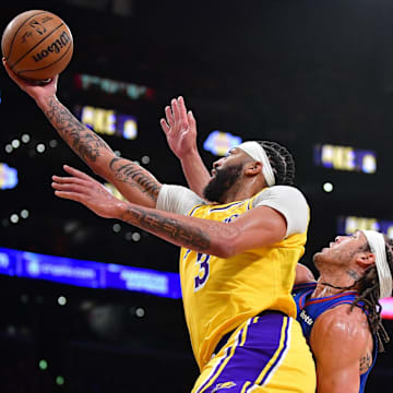 Apr 25, 2024; Los Angeles, California, USA; Los Angeles Lakers forward Anthony Davis (3) shoots ahead of Denver Nuggets forward Aaron Gordon (50) during the second half in game three of the first round for the 2024 NBA playoffs at Crypto.com Arena. Mandatory Credit: Gary A. Vasquez-Imagn Images