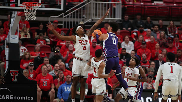 Jan 29, 2025; Lubbock, Texas, USA;  Texas Tech Red Raiders forward JT Toppin (15) blocks a shot by Texas Christian Horned Frogs guard Bendan Wenzel (0) in the first half at United Supermarkets Arena. Mandatory Credit: Michael C. Johnson-Imagn Images