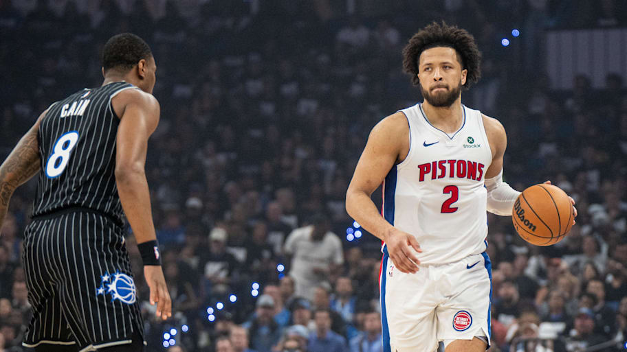 Pistons guard Cade Cunningham dribbles the ball against Magic forward Jamal Cain.