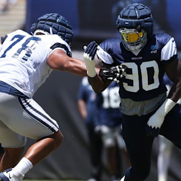 Dallas Cowboys defensive end DeMarcus Lawrence rushes against offensive tackle Terence Steele during training camp.