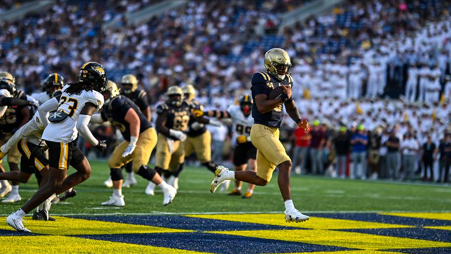 Navy Midshipmen quarterback Braxton Woodson scores a second half touchdown against the Towson Tigers.