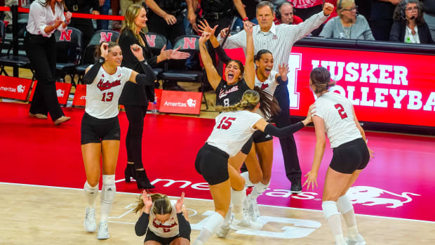 The Nebraska Cornhuskers celebrate after defeating the Wisconsin Badgers in five sets at the Bob Devaney Sports Center.