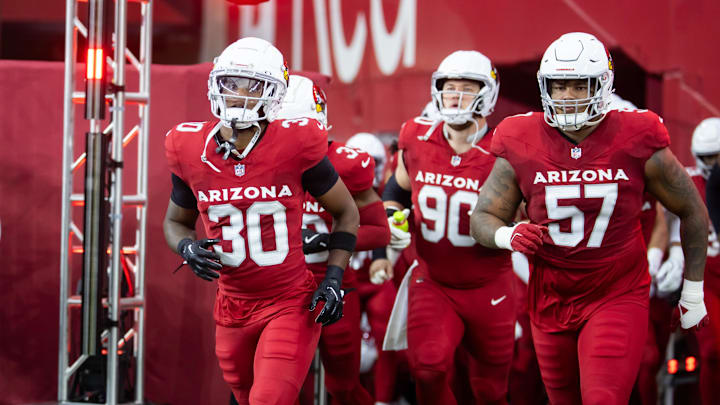 Aug 10, 2024; Glendale, Arizona, USA; Arizona Cardinals wide receiver Xavier Weaver (30) and defensive end Myles Murphy (57) against the New Orleans Saints during a preseason NFL game at State Farm Stadium. Mandatory Credit: Mark J. Rebilas-Imagn Images
