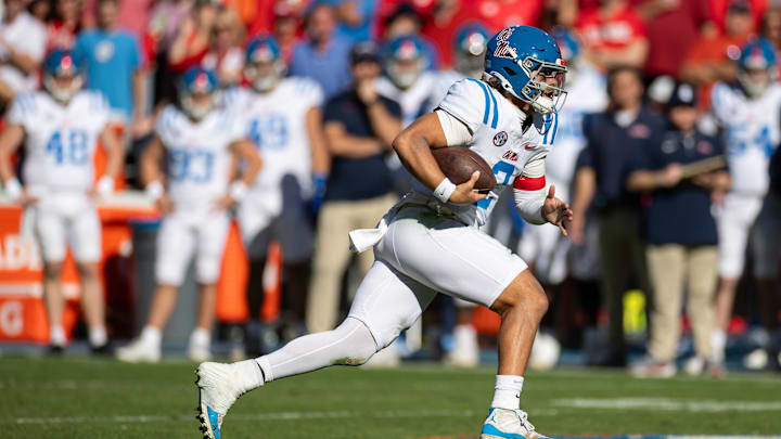 Nov 23, 2024; Gainesville, Florida, USA; Mississippi Rebels quarterback Jaxson Dart (2) rushes with the ball against the Florida Gators during the second half at Ben Hill Griffin Stadium. Mandatory Credit: Matt Pendleton-Imagn Images Nov 23, 2024; Gainesville, Florida, USA; Mississippi Rebels quarterback Jaxson Dart (2) rushes with the ball against the Florida Gators during the second half at Ben Hill Griffin Stadium. Mandatory Credit: Matt Pendleton-Imagn Images