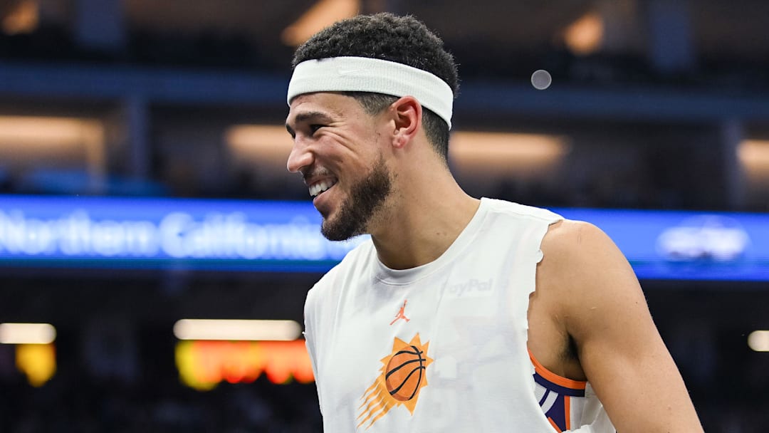 Nov 26, 2025; Sacramento, California, USA; Phoenix Suns guard Devin Booker (1) smiles on the sideline during the second quarter of the game against the Sacramento Kings at Golden 1 Center. Mandatory Credit: Ed Szczepanski-Imagn Images
