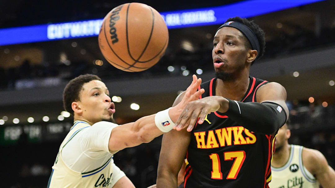 Mar 4, 2026; Milwaukee, Wisconsin, USA; Atlanta Hawks center Onyeka Okongwu (17) passes the ball away from Milwaukee Bucks guard Ryan Rollins (13) in the fourth quarter at Fiserv Forum. Mandatory Credit: Benny Sieu-Imagn Images