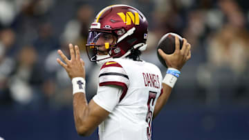 Jan 5, 2025; Arlington, Texas, USA; Washington Commanders quarterback Jayden Daniels (5) throws a pass against the Dallas Cowboys during the first quarter at AT&T Stadium. Mandatory Credit: Tim Heitman-Imagn Images