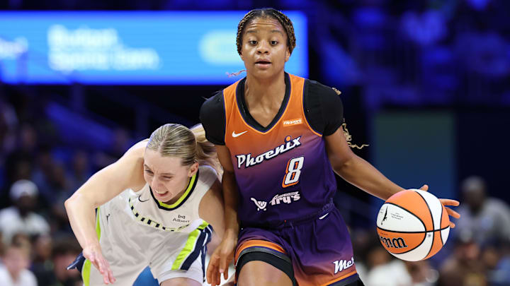 Jul 3, 2025; Arlington, Texas, USA;  Phoenix Mercury guard Monique Akoa Makani (8) dribbles as Dallas Wings guard Paige Bueckers (5) defends during the second half at College Park Center. Mandatory Credit: Kevin Jairaj-Imagn Images