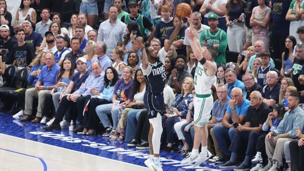 Dallas Mavericks forward Derrick Jones Jr. blocks a shot by Boston Celtics guard Payton Pritchard.