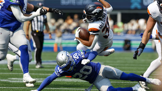 Seahawks safety Julian Love tackles Broncos running back Jaleel McLaughlin