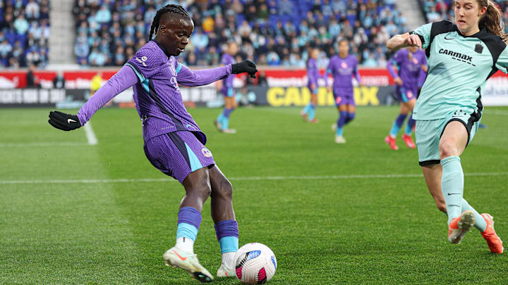 Mar 23, 2025; Harrison, New Jersey, USA; Orlando Pride forward Prisca Chilufya (9) kicks the ball as Gotham FC defender Tierna Davidson (15) defends during the first half at Sports Illustrated Stadium. Mandatory Credit: Vincent Carchietta-Imagn Images