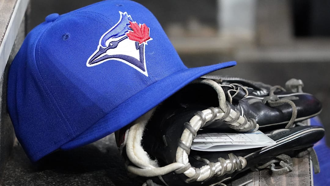 Apr 16, 2025; Toronto, Ontario, CAN; A Toronto Blue Jays hat and glove in the dugout during a game against the Atlanta Braves at Rogers Centre. 