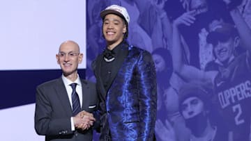 Yanic Konan Niederhauser stands with NBA commissioner Adam Silver