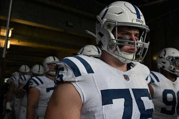 Indianapolis Colts guard Will Fries stands with teammates in a white jersey.