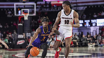 Nov 4, 2024; Athens, Georgia, USA; Tennessee Tech Golden Eagles guard Jaylon Johnson (3) dribbles against Georgia Bulldogs forward RJ Godfrey (10) at Stegeman Coliseum. Mandatory Credit: Dale Zanine-Imagn Images