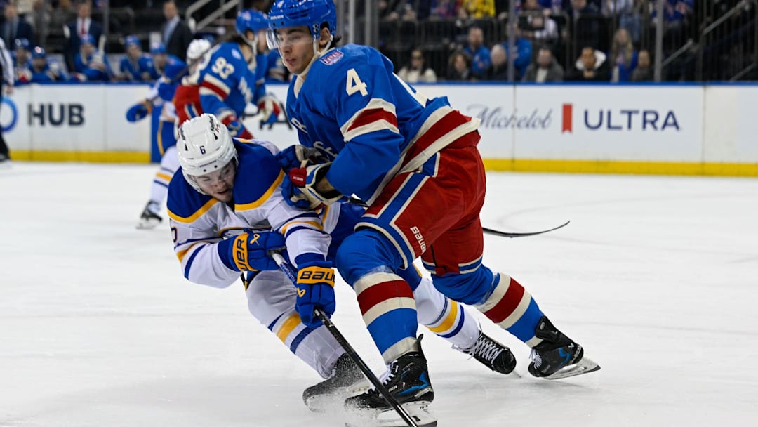 Apr 8, 2026; New York, New York, USA; New York Rangers defenseman Braden Schneider (4) checks Buffalo Sabres left wing Zach Benson (6) during the first period at Madison Square Garden. Mandatory Credit: Dennis Schneidler-Imagn Images