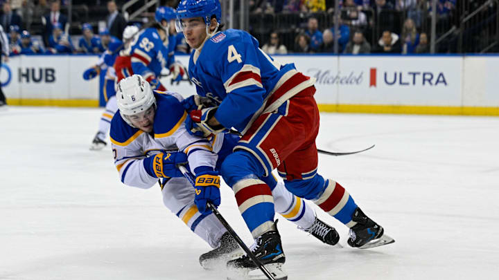 Apr 8, 2026; New York, New York, USA; New York Rangers defenseman Braden Schneider (4) checks Buffalo Sabres left wing Zach Benson (6) during the first period at Madison Square Garden. Mandatory Credit: Dennis Schneidler-Imagn Images
