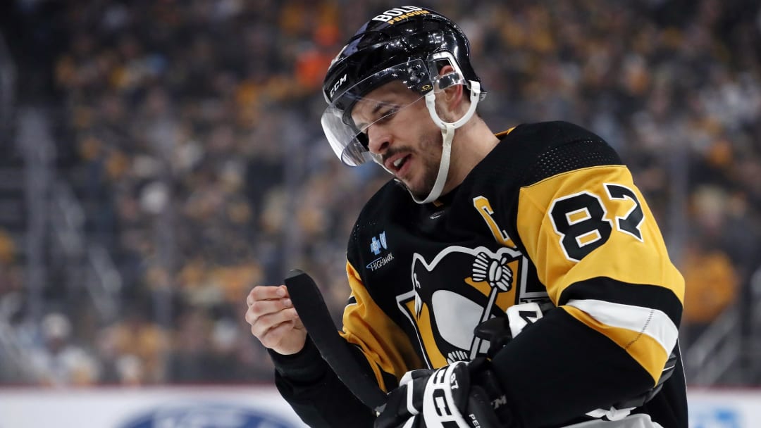 Apr 15, 2024; Pittsburgh, Pennsylvania, USA;  Pittsburgh Penguins center Sidney Crosby (87) prepares his stick before a face-off against the Nashville Predators during the first period at PPG Paints Arena. The Penguins won 4-2.