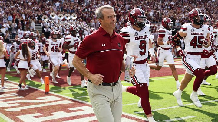 Nov 15, 2025; College Station, Texas, USA; South Carolina Gamecocks head coach Shane Beamer runs onto the field with players before the game against the Texas A&M Aggies at Kyle Field. Mandatory Credit: Troy Taormina-Imagn Images
