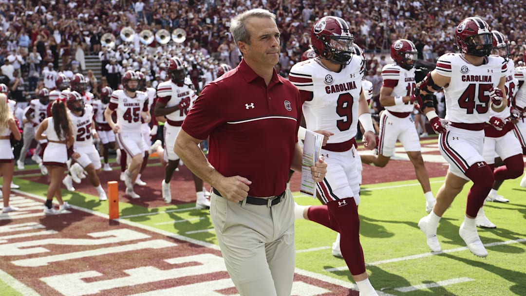 Nov 15, 2025; College Station, Texas, USA; South Carolina Gamecocks head coach Shane Beamer runs onto the field with players before the game against the Texas A&M Aggies at Kyle Field. Mandatory Credit: Troy Taormina-Imagn Images