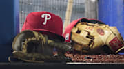 Aug 16, 2023; Toronto, Ontario, CAN; A Philadelphia Phillies cap and glove sit in the dugout during a game against the Toronto Blue Jays at Rogers Centre. Mandatory Credit: John E. Sokolowski-Imagn Images