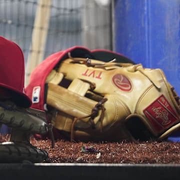 Aug 16, 2023; Toronto, Ontario, CAN; A Philadelphia Phillies cap and glove sit in the dugout during a game against the Toronto Blue Jays at Rogers Centre. Mandatory Credit: John E. Sokolowski-Imagn Images