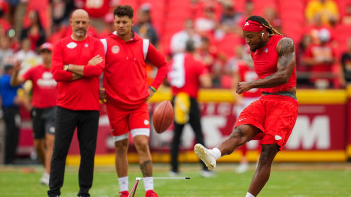 Aug 26, 2023; Kansas City, Missouri, USA; Kansas City Chiefs safety Justin Reid practices kicking field goals as offensive coordinator Matt Nagy and quarterback Patrick Mahomes look on prior to a game against the Cleveland Browns at GEHA Field at Arrowhead Stadium. Mandatory Credit: Jay Biggerstaff-USA TODAY Sports
