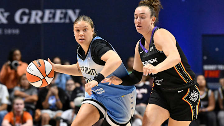 Aug 13, 2025; Uncasville, Connecticut, USA; Chicago Sky guard Rachel Banham (24) drives the ball against Connecticut Sun guard Marina Mabrey (3) during the first half at Mohegan Sun Arena. Mandatory Credit: Eric Canha-Imagn Images