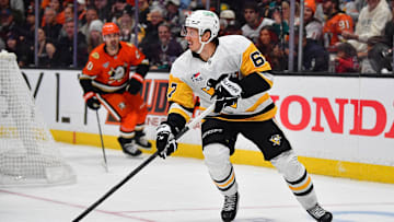 Oct 14, 2025; Anaheim, California, USA; Pittsburgh Penguins right wing Rickard Rakell (67) controls the puck against the Anaheim Ducks during the second period at Honda Center. Mandatory Credit: Gary A. Vasquez-Imagn Images