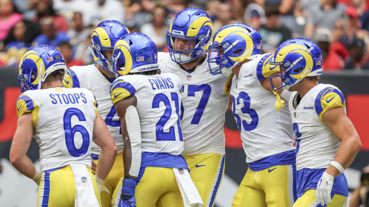 Aug 24, 2024; Houston, Texas, USA; Los Angeles Rams running back Zach Evans (21) celebrates his touchdown with quarterback Dresser Winn (4) and teammates  against the Houston Texans in the second quarter at NRG Stadium. Mandatory Credit: Thomas Shea-USA TODAY Sports