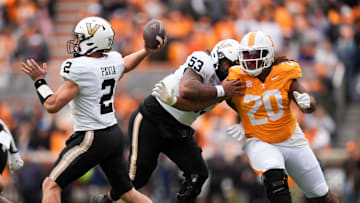 Vanderbilt quarterback Diego Pavia (2) pulls back for the throw as offensive lineman Jordan White (53) tries to hold back Tennessee defensive lineman Bryson Eason (20) in an NCAA college football game on Nov. 29, 2025, in Knoxville, Tennessee.