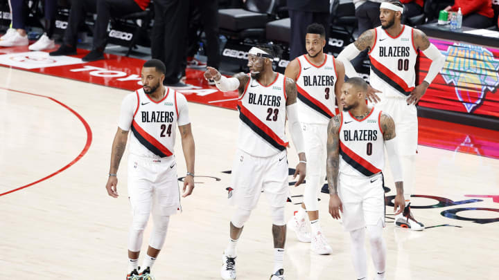 May 27, 2021; Portland, Oregon, USA; Portland Trail Blazers (from left to right) Norman Powell (24), Robert Covington (23), Damian Lillard (0), CJ McCollum (3) and Carmelo Anthony (00) walk back to the court after a timeout during the second half of game three in the first round of the 2021 NBA Playoffs against the Denver Nuggets at Moda Center. Mandatory Credit: Soobum Im-USA TODAY Sports