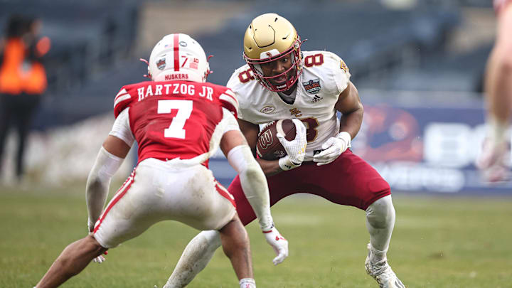 Dec 28, 2024; Bronx, NY, USA; Boston College Eagles wide receiver Johnathan Montague Jr. (8) is tackled by Nebraska Cornhuskers defensive back Malcolm Hartzog Jr. (7) during the first half at Yankee Stadium. Mandatory Credit: Vincent Carchietta-Imagn Images
