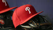 May 25, 2022; Atlanta, Georgia, USA; Detailed view of a Philadelphia Phillies hat and glove in the dugout against the Atlanta Braves in the eighth inning at Truist Park. Mandatory Credit: Brett Davis-Imagn Images