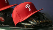 May 25, 2022; Atlanta, Georgia, USA; Detailed view of a Philadelphia Phillies hat and glove in the dugout against the Atlanta Braves in the eighth inning at Truist Park.