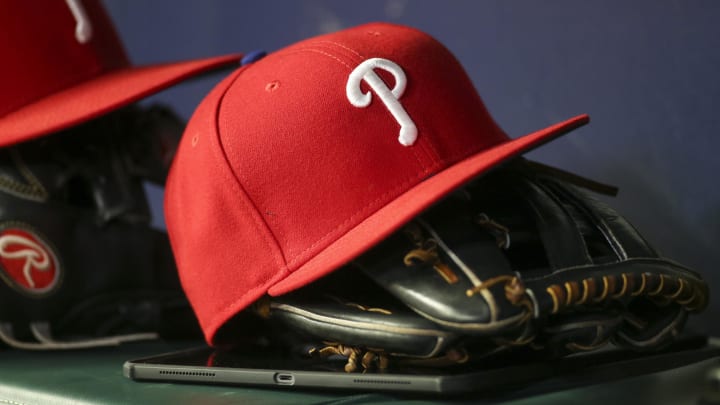 May 25, 2022; Atlanta, Georgia, USA; Detailed view of a Philadelphia Phillies hat and glove in the dugout against the Atlanta Braves in the eighth inning at Truist Park.