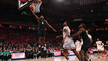 Jan 25, 2025; New York, New York, USA; Michigan State Spartans guard Tre Holloman (5) goes to the basket against the Rutgers Scarlet Knights during the second half at Madison Square Garden. Mandatory Credit: Vincent Carchietta-Imagn Images